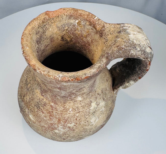 Small Roman or Byzantine terracotta jug with flared rim and large strap handle