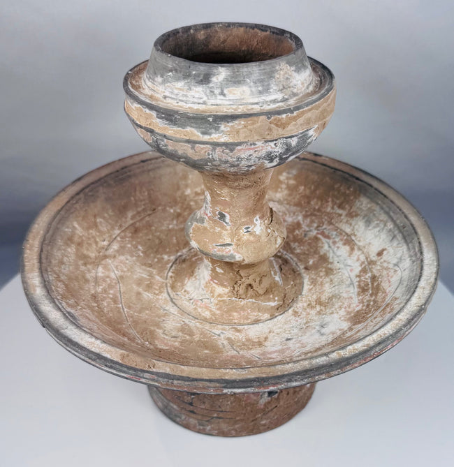 Terracotta ritual stand with mineral deposits and surviving painted decoration