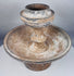 Terracotta ritual stand with mineral deposits and surviving painted decoration
