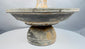 Ancient Mediterranean ceremonial vessel with elevated cup and surrounding catch basin