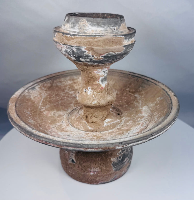Near Eastern terracotta pedestal lamp or offering vessel with aged encrustation