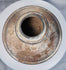 Ancient ritual pottery vessel with black painted bands and weathered surface