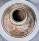 Ancient ritual pottery vessel with black painted bands and weathered surface