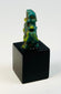 Blue-green faience Bes amulet from ancient Egypt with archaeological patina.