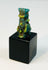 Ancient Egyptian protective charm depicting Bes with stylized facial features.