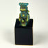 Rear view of Ancient Egyptian Bes faience amulet showing surface wear and glaze texture