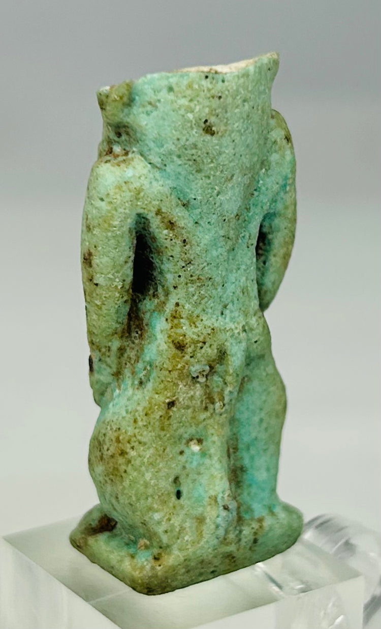 Ancient Egyptian faience amulet depicting dwarf-god Bes associated with protection and joy
