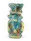 Small Egyptian faience Bes amulet with turquoise glaze and suspension hole for wearing as a charm.