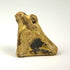 Ancient Egyptian crouching falcon pendant amulet with suspension perforation, natural patina, and worn stone surface.