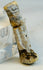 Macro photograph highlighting mineral deposits and aged surface of Egyptian amulet.