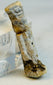 Macro photograph highlighting mineral deposits and aged surface of Egyptian amulet.