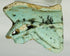 Blue-green faience Eye of Horus amulet shard from Ancient Egypt displayed on white background
