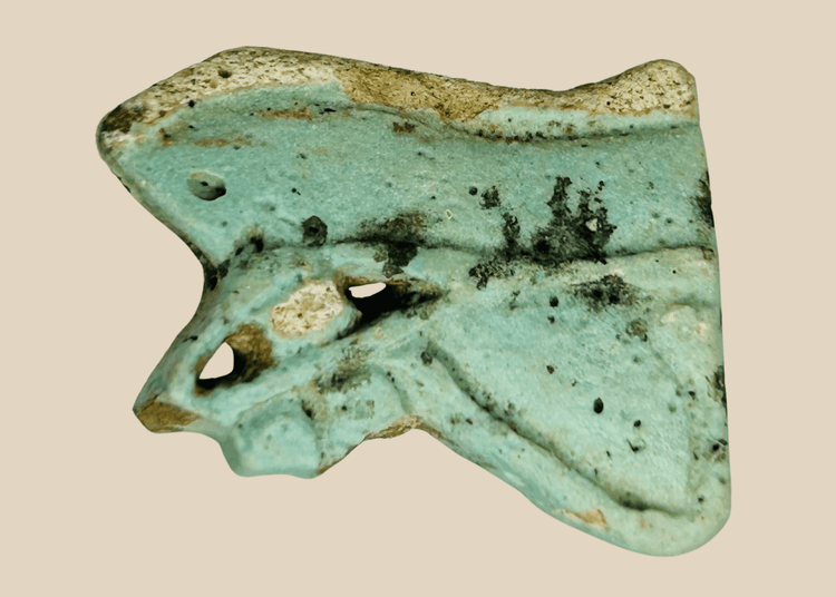 Ancient Egyptian faience Eye of Horus amulet fragment in blue-green glaze with burial patina