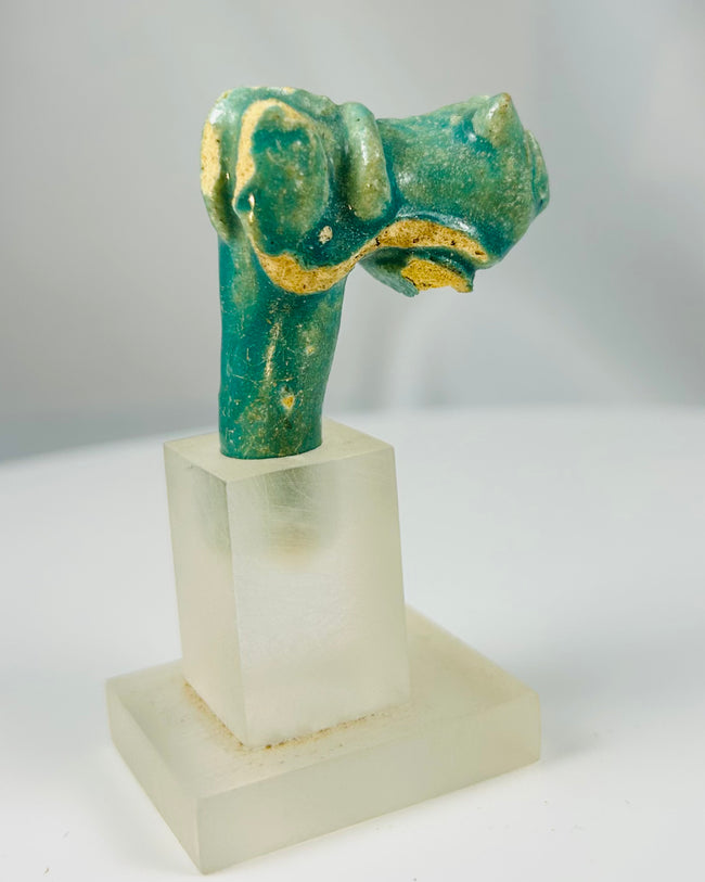 Ancient Egyptian Bastet vessel ornament fragment in blue-green faience glaze.