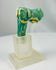 Ancient Egyptian Bastet vessel ornament fragment in blue-green faience glaze.