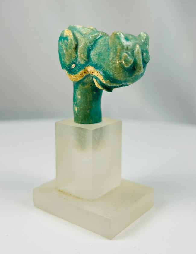Egyptian faience vessel handle fragment with sculpted cat head associated with Bastet.