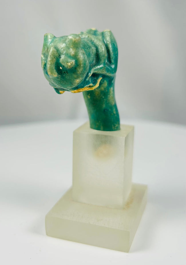 Late Period Egyptian faience fragment depicting a stylized cat head on vessel handle.