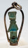 Side view of an Egyptian faience amulet showing its original suspension perforation