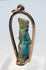 Front view of an ancient Egyptian divine figure amulet mounted as gold jewelry