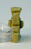 Ancient Egyptian Bes amulet with pale green glaze and suspension hole.