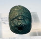 Front view of blue-green Egyptian scarab showing the longitudinal suspension perforation