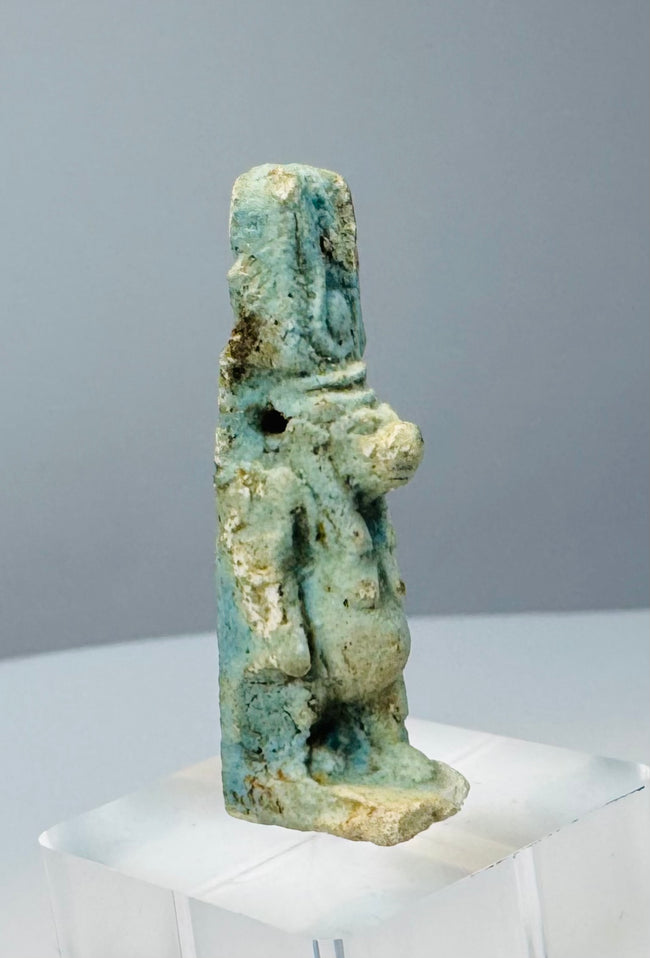 Reverse view of a Late Period Egyptian Taweret amulet showing deep blue glaze remnants
