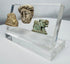 Faience Hathor amulet accompanied by carved stone lion and classical portrait fragment from antiquity.
