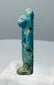Close view of the feline head and worn headdress on an Egyptian protective goddess amulet