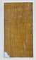 Close-up of the larger attributed mummy-wrapping fragment, showing woven linen texture, frayed edges and narrow separations.