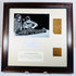 Dark wood frame displaying two attributed Manchester Mummy 1770 linen fragments beside a photograph of the 1975 investigation.