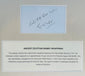 Handwritten inscription above an identification panel describing the history of the attributed Egyptian mummy wrappings.