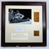 Full view of the Manchester Mummy 1770 display with cream fabric mount, dark wooden frame and contrasting inner border.