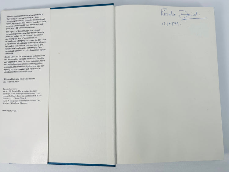Open copy of Mysteries of the Mummies showing the dust-jacket flap and Rosalie David’s signed front endpaper.