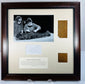 Framed mummy-wrapping display showing ancient linen, documentary photograph and accompanying notes beneath glazing.