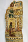 Upper section close-up of coffin panel with large blue-green scarab and kneeling figure before shrine