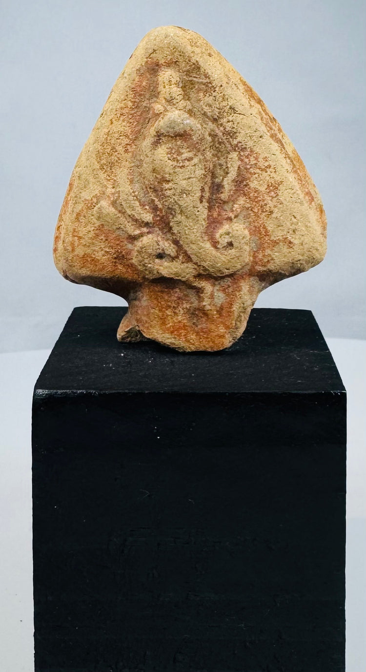 Fragmentary Egyptian cobra ornament mounted on a modern black wooden stand