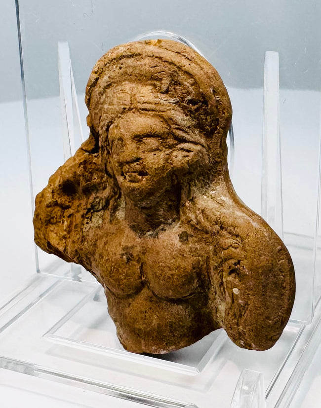 Ptolemaic Egyptian clay figurine fragment with female facial features and Hellenistic-influenced hairstyle.