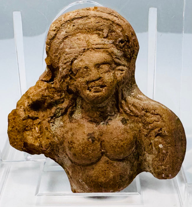 Small Ptolemaic period clay sculpture fragment depicting part of a female figure with preserved head and upper body.