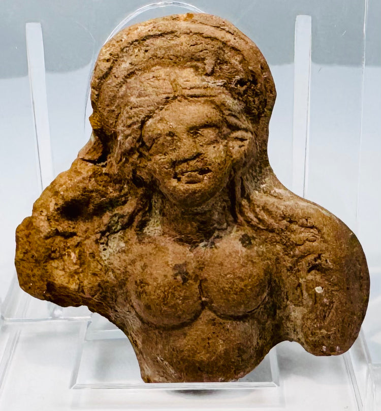 Small Ptolemaic period clay sculpture fragment depicting part of a female figure with preserved head and upper body.