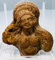 Small Ptolemaic period clay sculpture fragment depicting part of a female figure with preserved head and upper body.