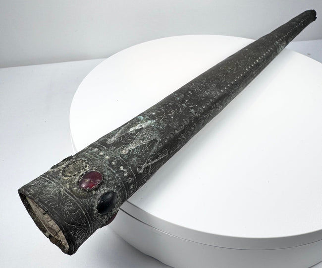 Ornamental scabbard with foliate decoration, a fractured red insert and vacant settings.