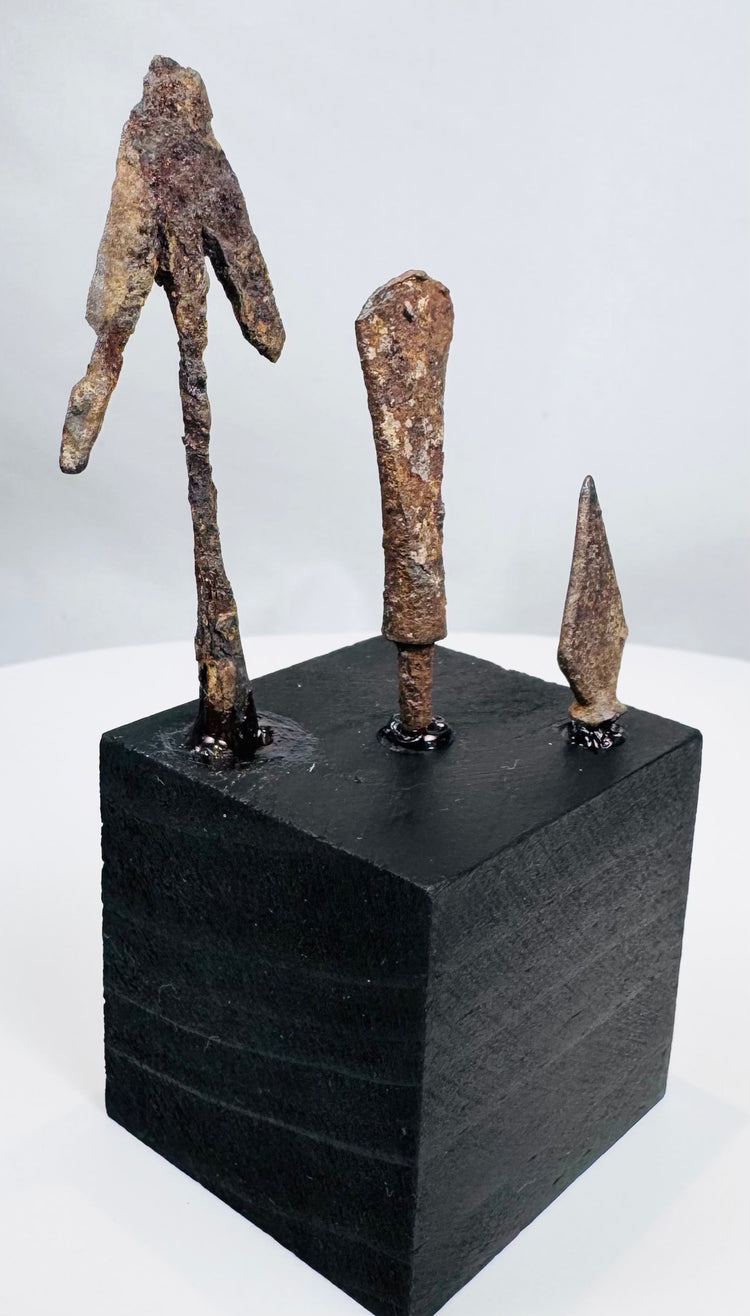 Three archaeological iron projectile heads including tanged and barbed forms