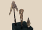 Group of three ancient and medieval iron projectile points on black display bases