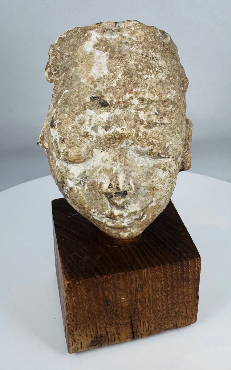 Ancient Gandharan stucco head displaying centuries of weathering and surface erosion