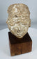 Ancient Gandharan stucco head displaying centuries of weathering and surface erosion