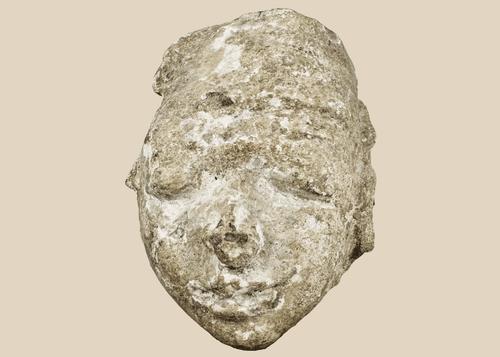 Ancient Gandharan Buddhist stucco head fragment mounted on a wooden display base