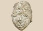 Ancient Gandharan Buddhist stucco head fragment mounted on a wooden display base