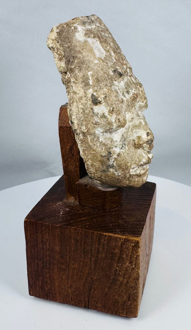 Archaeological Gandharan stucco sculpture fragment with calm meditative expression