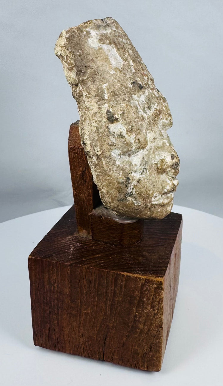 Archaeological Gandharan stucco sculpture fragment with calm meditative expression