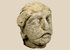 Ancient Gandharan limestone head fragment depicting a Bodhisattva traditionally identified as Maitreya, dating to the Kushan Period.